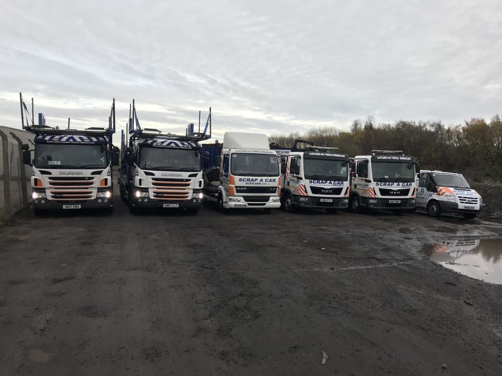 The Scrap A Car Scotland transporter and recovery fleet lined up at the Thornton yard in Fife - covering scrap car collection in Stirling, Central